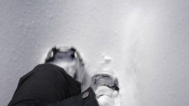 a man legs  walking in the snow.