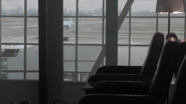 airport interior with a window and a glass of water
