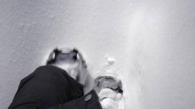 a man legs  walking in the snow.