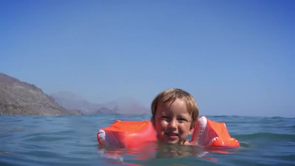 Wesoły Chłopiec Uczy Się Pływać Morzu — Wideo stockowe