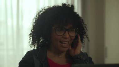 Latin American Woman Speaking using Headset at Home