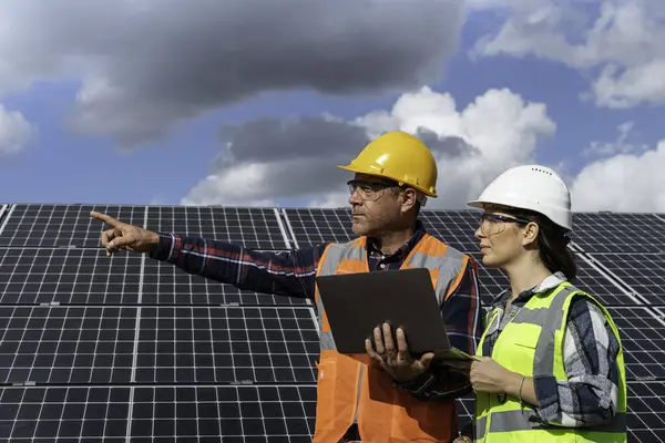 male engineers with solar panels on roof