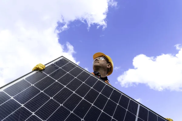 man with installation of solar panels make on solar panel plant.