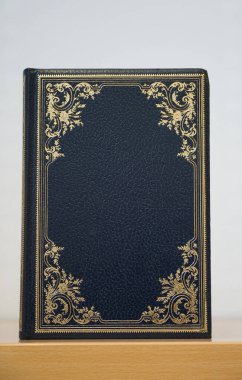 Blue and blank cover old lexicon book in vertical position with golden decorative roses clipart