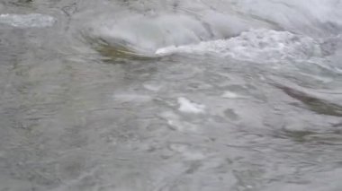 Mountain river with clear water from melting snow and ice