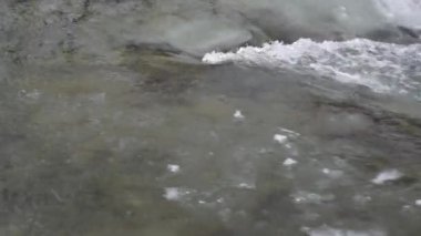 Mountain river with clear water from melting snow and ice
