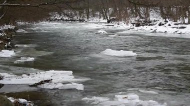 Mountain river with clear water from melting snow and ice