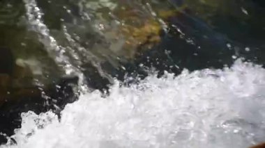 Mountain river with clear water from melting snow and ice