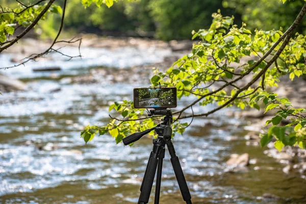 stock image Shooting a mountain river with a smartphone