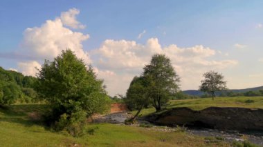 Gün batımında dağlarda bir nehrin bahar manzarası