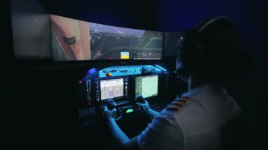 Side view of concentrated female pilot sitting in cabin of airplane. Young woman wearing uniform holding, turning wheel, looking at screen. Concept of traveling by aviation.