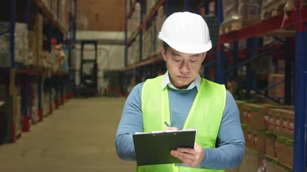 Mature Male Supervisor Clipboard Hands Standing Shelves Large Logistic Warehouse — Stock Video
