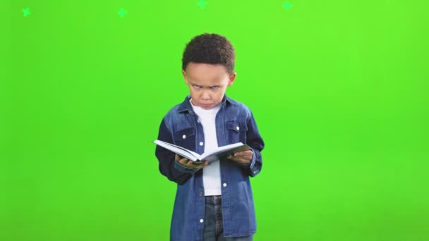 Disappointed Little African American Boy Holding Book Looking Camera Motion — Stock Video