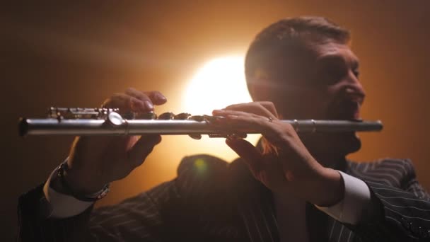 Close Handsome Adult Male Musician Playing Flute While Holding Instrument — Stock Video