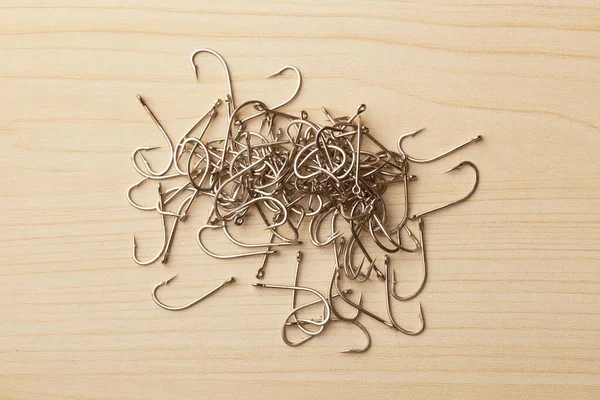Close Pile Fish Hooks Wooden Background Top View — Stock Photo, Image