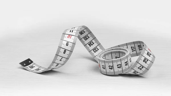 Measuring tape isolated on a white wooden background