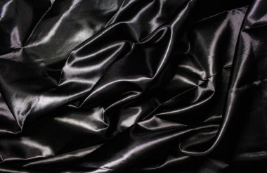 Abstract background, black wavy cloth texture.