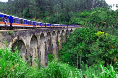 A social media craze includes couples photographing themselves hanging out of moving carriages as they cross the iconic Nine Arches Bridge, in Ella, Sri Lanka, on Tuesday, 10th September, 2024. clipart