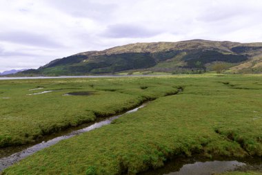 Leven Gölü denize açılıyor, Glencoe 'nun batısında, İskoçya İskoçya' da. Manzara gelgitlerin davranışlarıyla şekillenir..