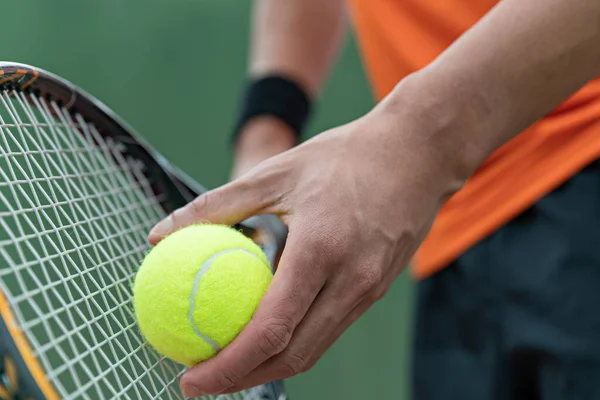 Man play tennis ball and tennis racquet, Professional tennis player, Sport and healthy lifestyle, concept of outdoor game sports, racket and green ball.