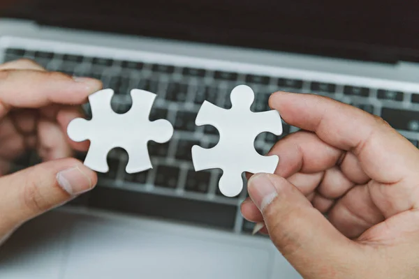 stock image Business man use white puzzle piece brainstorming and solution concept, engineer man connect jigsaw puzzle, concept success and strategy, asian young hold jigsaw puzzle.