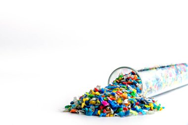 Ezilmiş küçük plastik parçaları. Geri dönüşüm için ezilmiş şişe kapakları. Plastik atıkla plastik kenar karışacak. Plastiği küçültme kavramı.