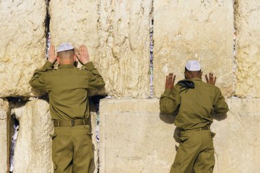 Israeli army IDF soldiers praying for peace at Western Wall in Jerusalem Old City during war with Hamas in Gaza that led to civilian deaths, hostage kidnapping and humanitarian crisis. clipart