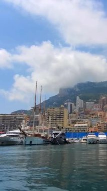 France, French Riviera, Monte Carlo marina with luxury yachts and cars in Monaco bay.