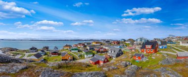 Typical architecture of Greenland capital Nuuk with colored houses located near fjords and icebergs. clipart