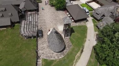Wooden Church and Tower in Timber Town, Mecavnik Hill, Mokra Gora, Serbia. Drone Birdseye Aerial View 4k