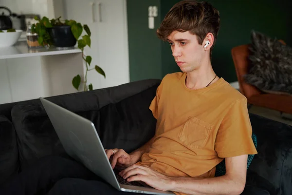 Young Caucasian Man Wearing Shirt Working Laptop Wireless Headphones Sofa — Stock Photo, Image