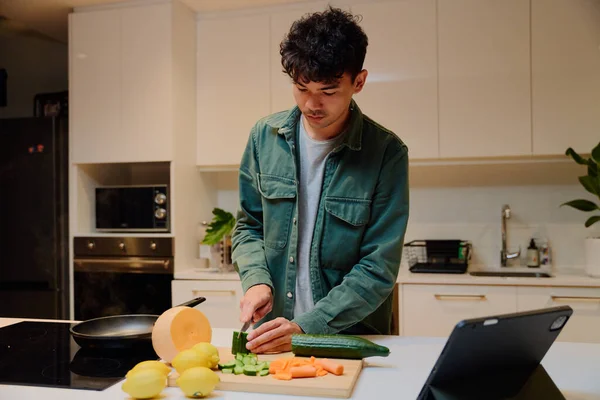 Young Multiracial Man Long Sleeved Shirt Cutting Vegetables Next Digital — Zdjęcie stockowe