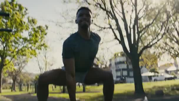 Joven Hombre Negro Con Mano Detrás Espalda Haciendo Sentadillas Con — Vídeo de stock