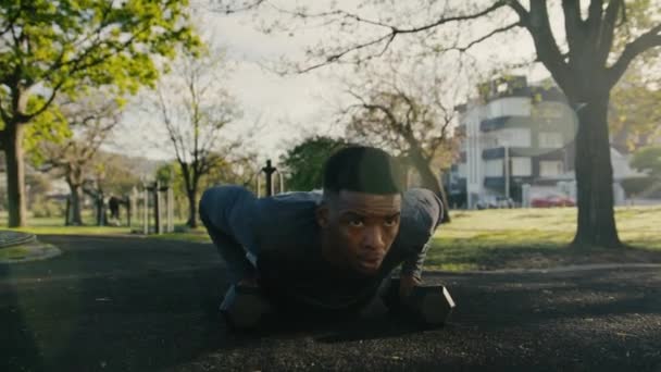 Young Black Man Sports Clothing Doing Push Ups Dumbbells Pavement — Stockvideo