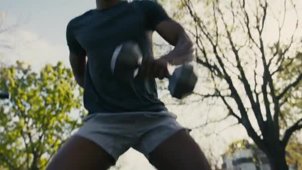 Young Black Man Shirt Shorts Hand Back Doing Squats Dumbbell — Stockvideo
