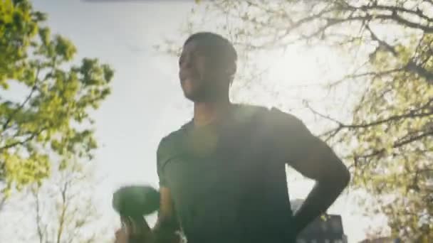 Young Black Man Shirt Shorts Wireless Headphones Doing Squats Dumbbell — Stock video