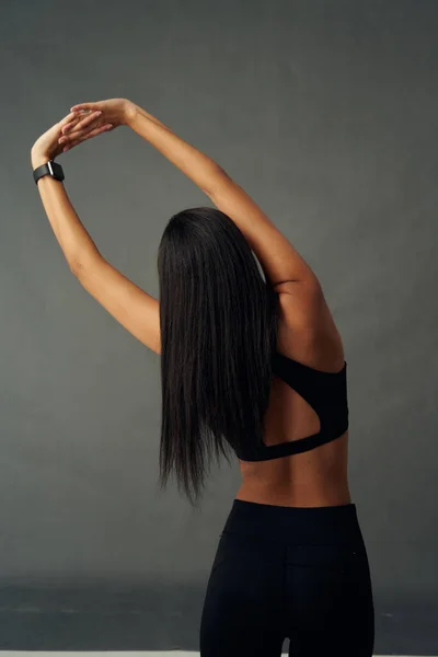 Rear View Young Biracial Woman Wearing Sports Clothing While Stretching — Fotografia de Stock