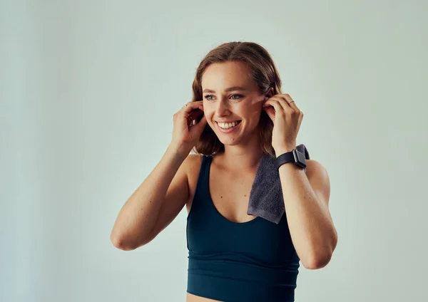 Happy Young Caucasian Woman Sports Bra Looking Away While Putting — Foto Stock
