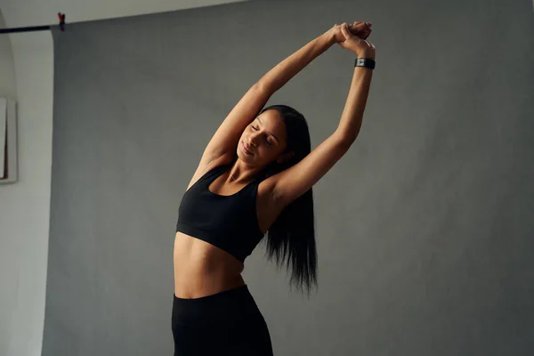 Young Biracial Woman Sportswear Fitness Tracker Arms Raised Stretch Studio — Fotografia de Stock