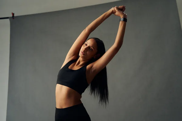 Focused Young Biracial Woman Sportswear Fitness Tracker Arms Raised Stretch — Foto de Stock