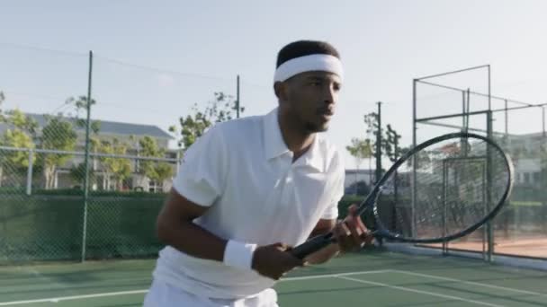 Athletic Young Black Man Wearing Headband Hitting Ball Tennis Racquet — Stockvideo