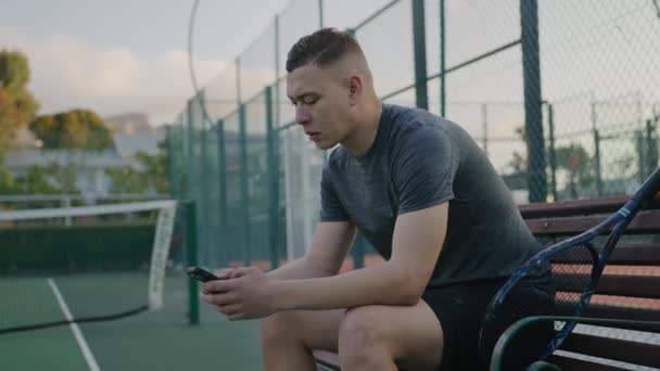 Young Biracial Man Sportswear Taking Break Using Mobile Phone Tennis — Αρχείο Βίντεο