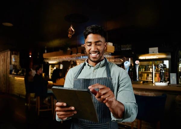 Happy Young Biracial Man Wearing Apron Pointing Digital Tablet While — Stock Photo, Image