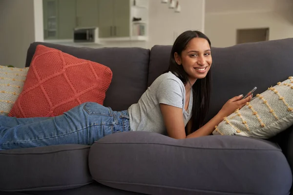 Happy Young Biracial Woman Wearing Casual Clothing Lying Sofa Mobile — Stock Photo, Image