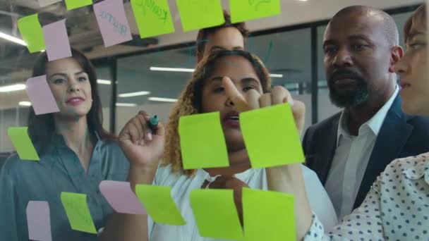 Grupo Compañeros Trabajo Multirraciales Hablando Mientras Usan Notas Adhesivas Multicolores — Vídeos de Stock