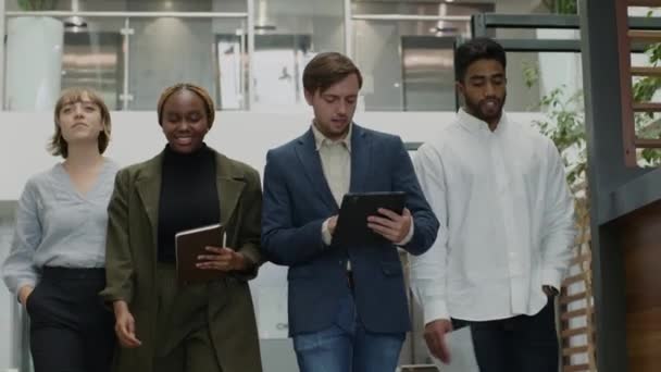 Four Multiracial Young Adults Wearing Businesswear Smiling While Walking Talking — Stock Video