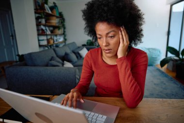 Mixed Race student stressed about her up coming exam in a modern apartment. High quality photo clipart