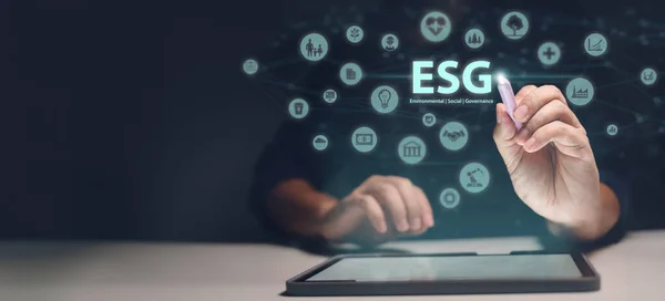 Explore the essence of ESG - Environmental, Social, and Governance. A man engages with a holographic representation of the letters \'ESG\', emphasizing the importance of these core concepts in responsible business practices.