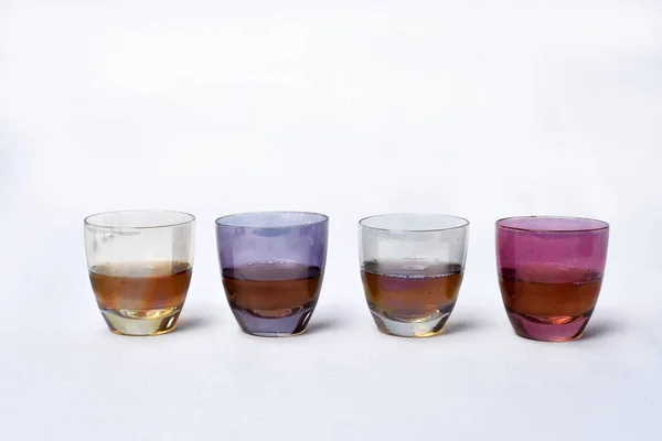 colored glass goblet with cognac and cheese