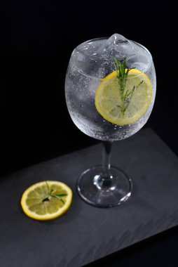 alcoholic iced drink of gin and tonic vodka soda citrus fruit juice lemonade with cinnamon isolated on black background